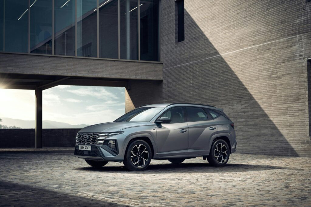 Stylish Hyundai SUV in urban setting, showcasing sleek design and modern architecture.